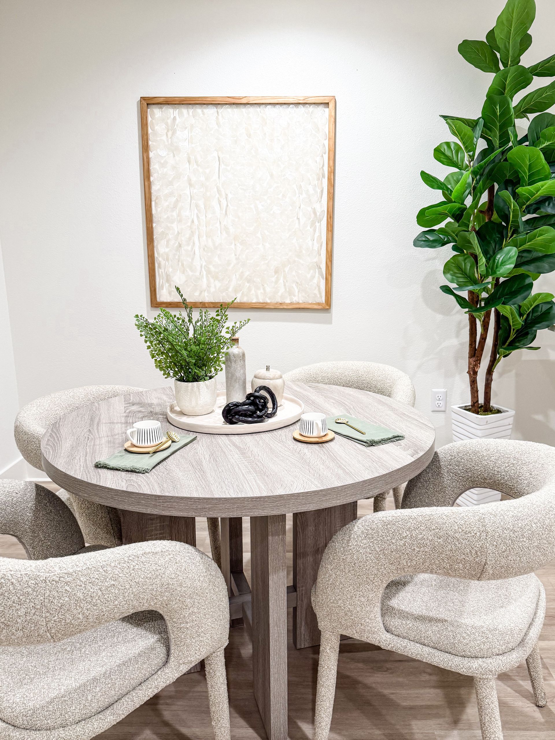 dining room set in apartment complex in Biloxi with large plants and natural decor