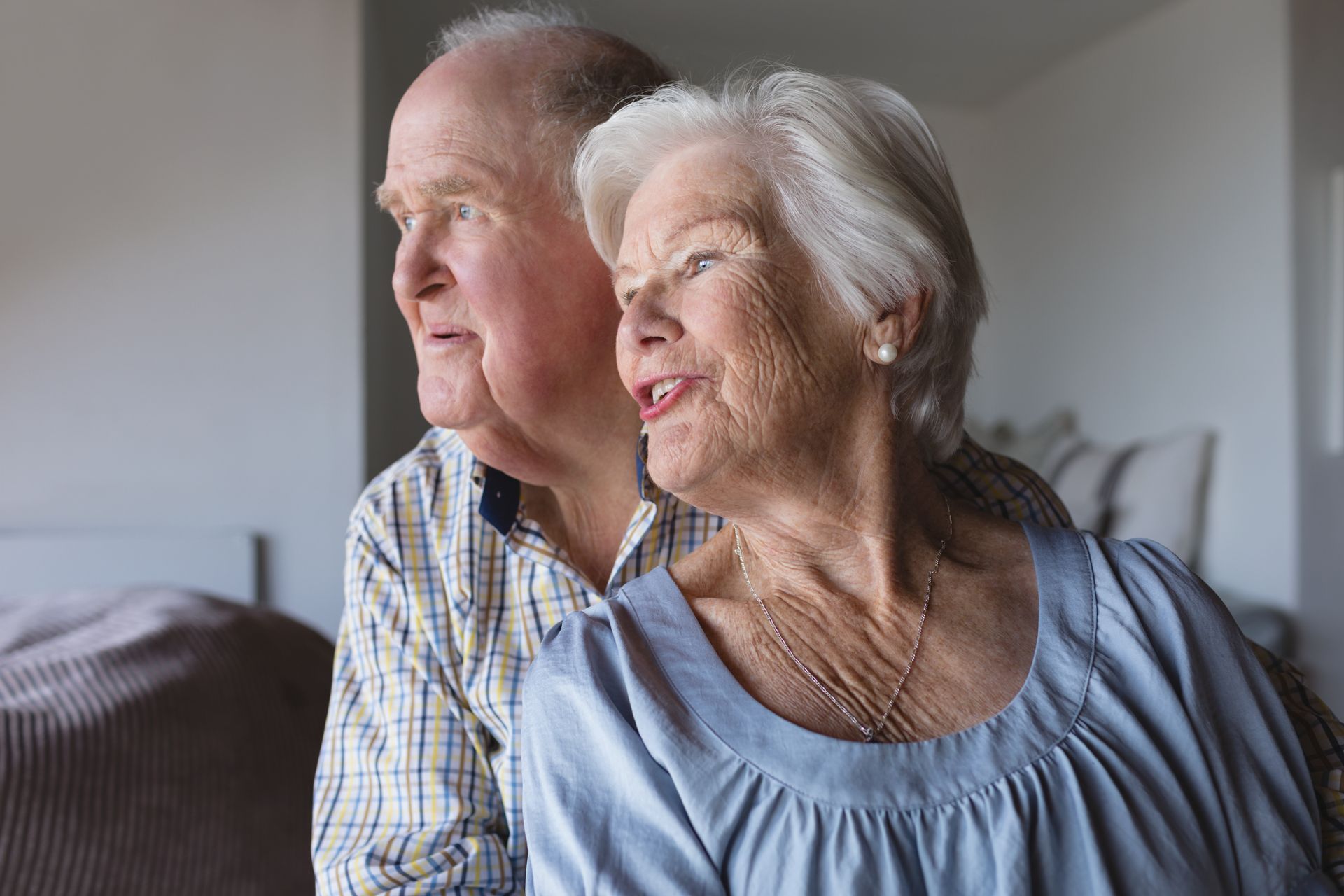 A man and a woman are sitting next to each other on a couch.