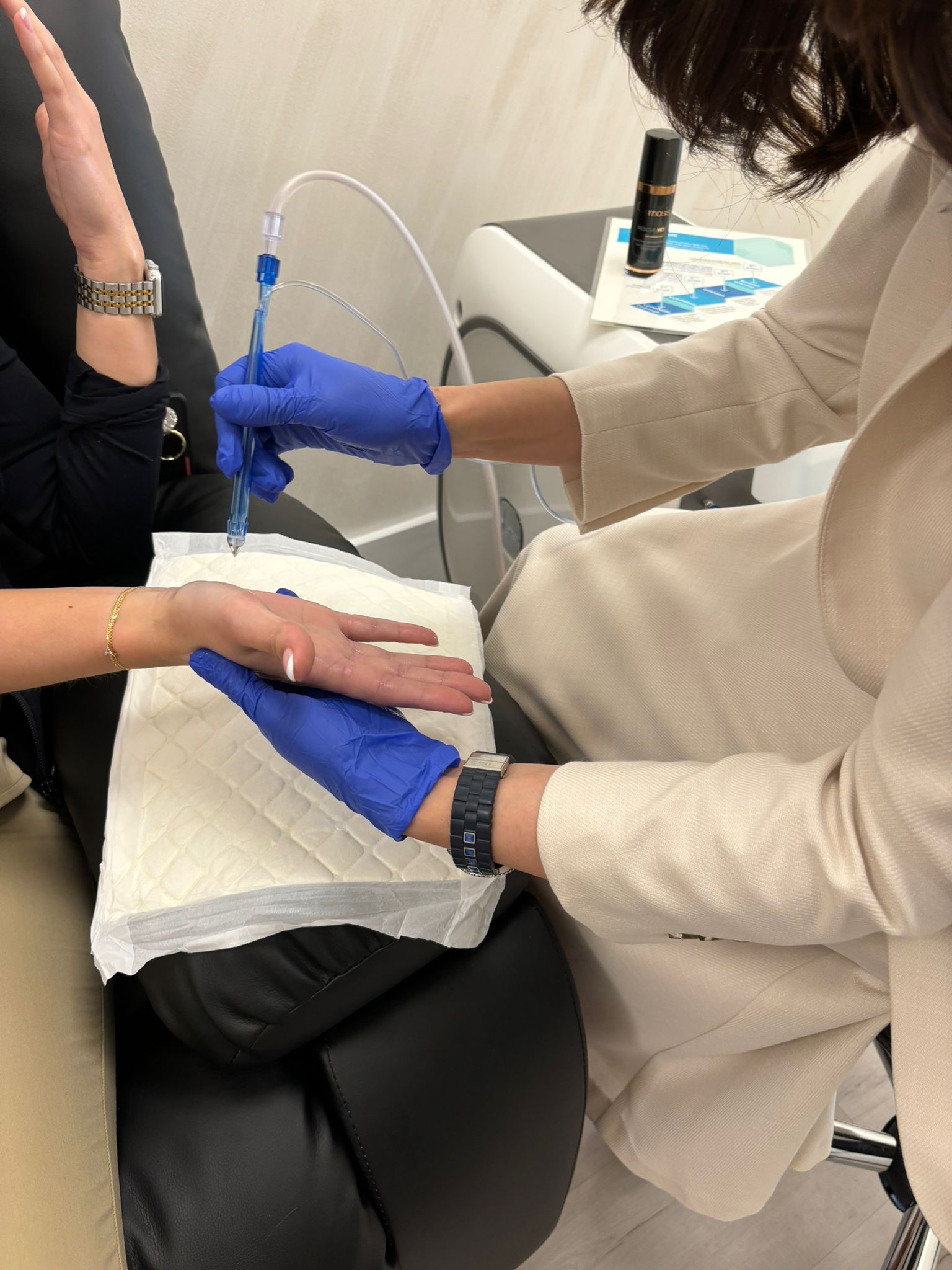 A woman wearing blue gloves is giving a high five to another woman.