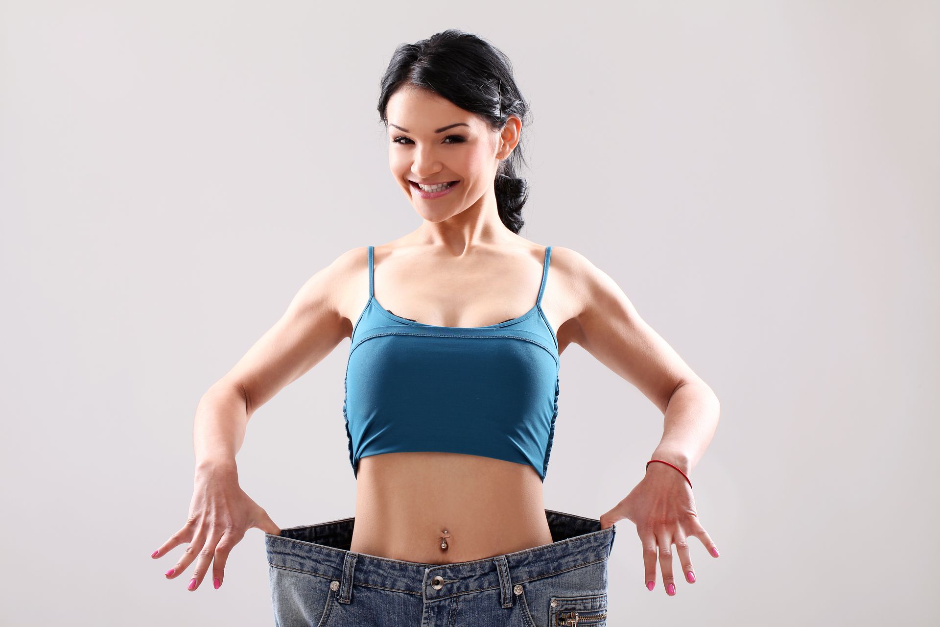 A woman is wearing a blue tank top and black jeans.