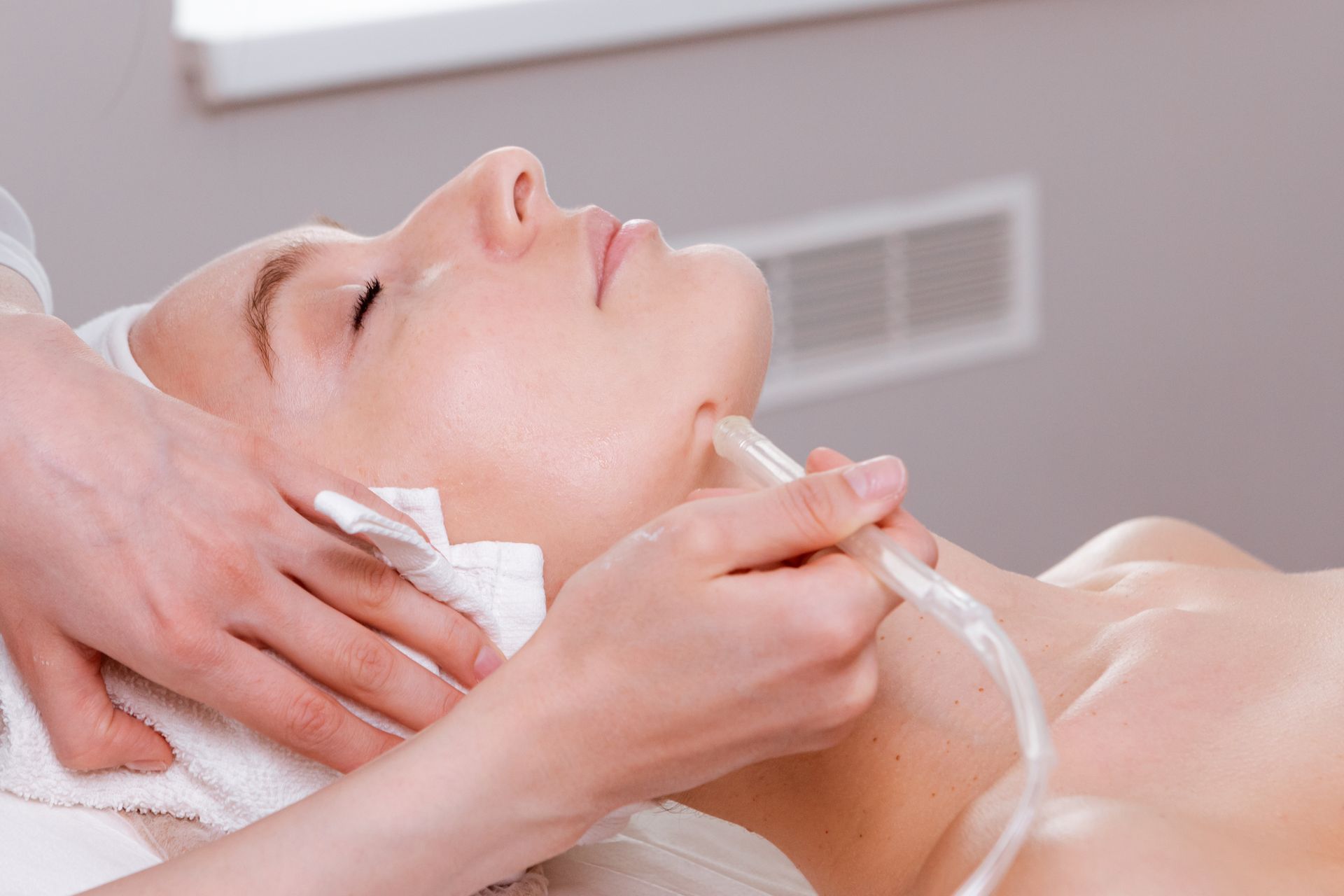 A woman is getting a facial treatment at a spa.