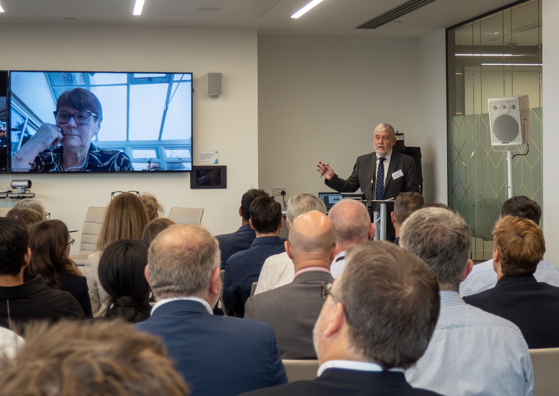 A group of people are sitting in a room at a conference.
