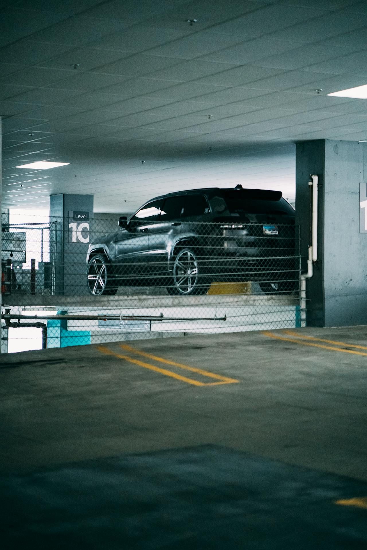 A black suv is parked in a parking garage.