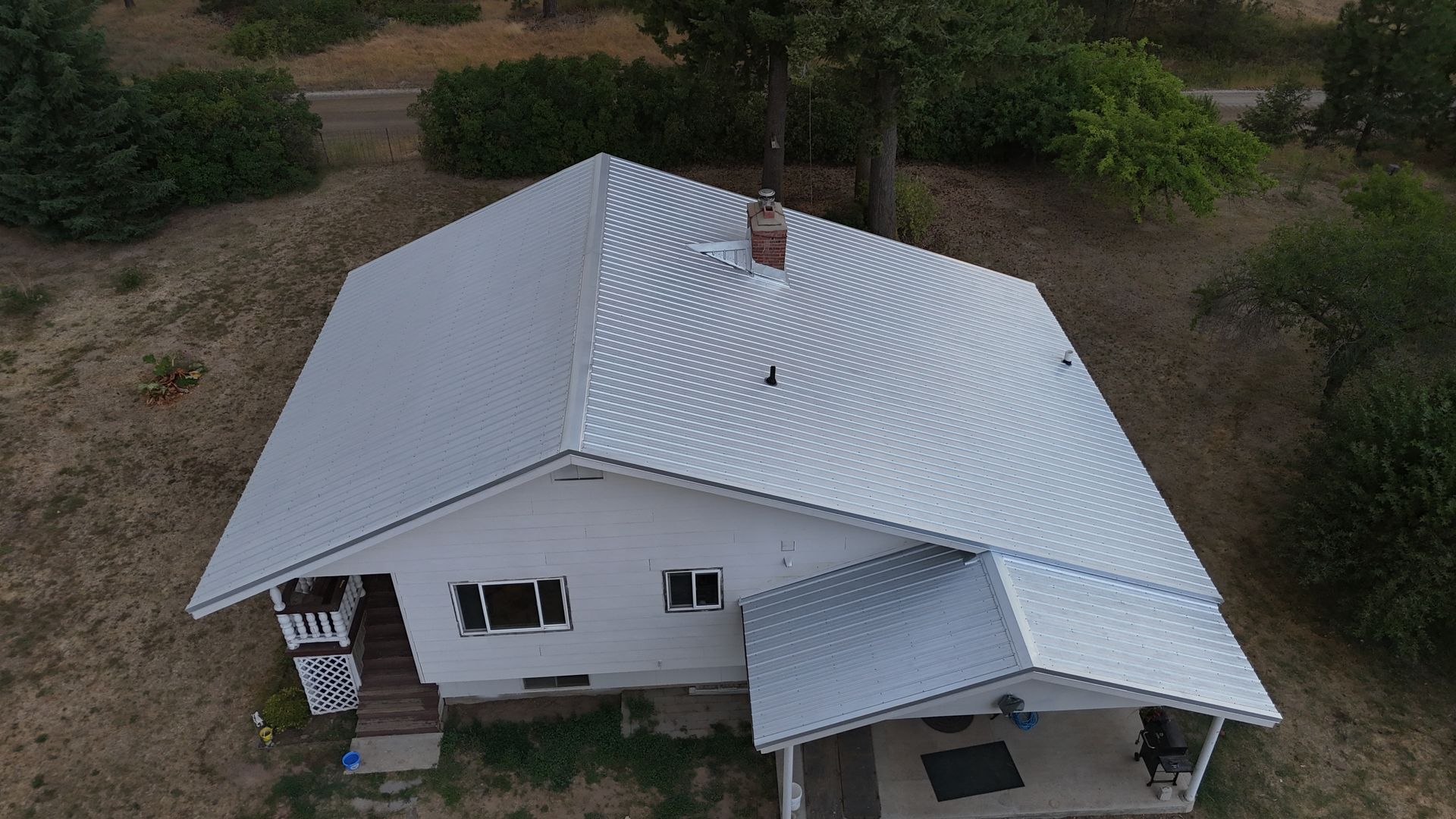 Close-up of a dark gray metal roof with a wavy, textured design.
