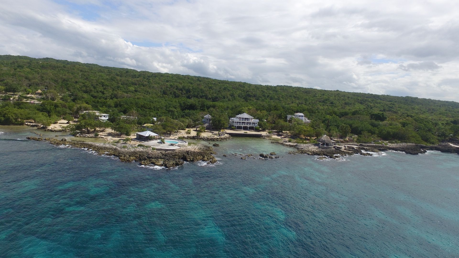 An aerial view of a small island in the middle of the ocean.