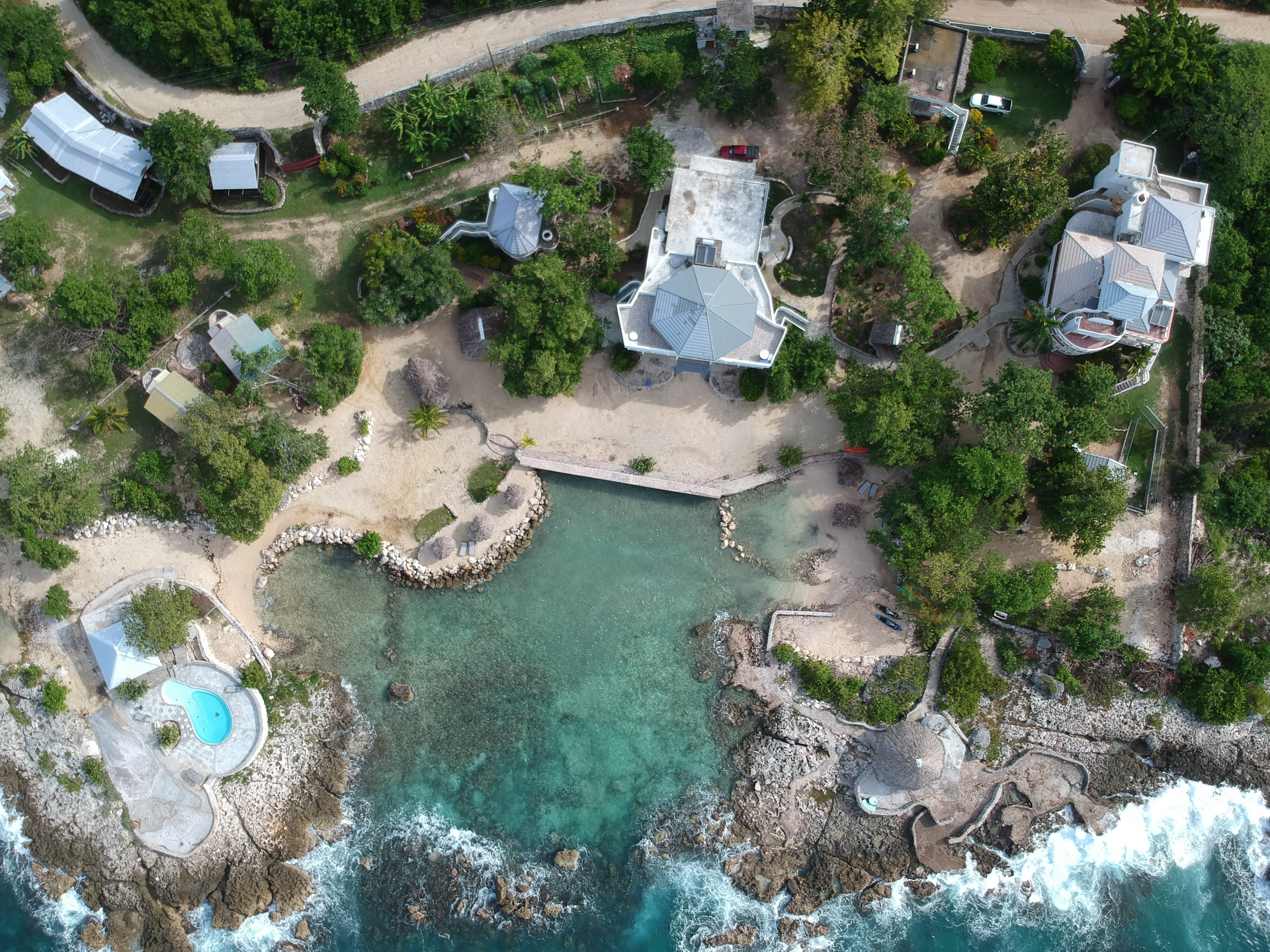 An aerial view of a tropical island with a large body of water