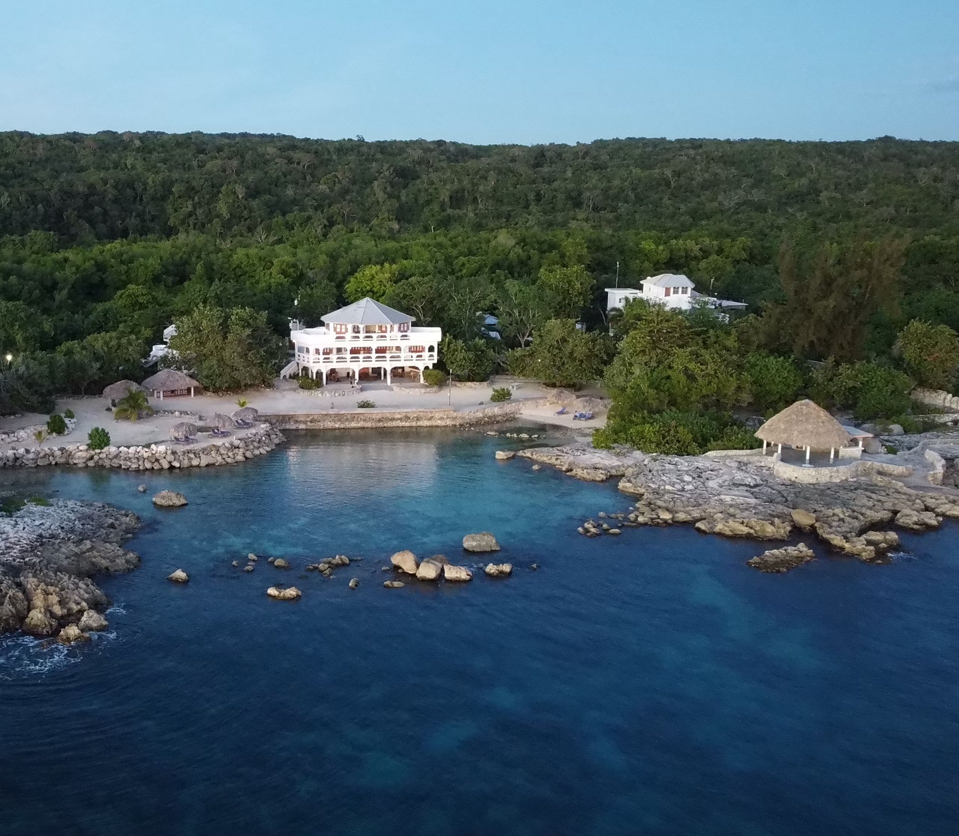 An aerial view of a house in the middle of a body of water