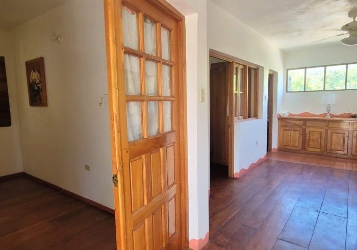 There is a wooden door in the middle of a room.