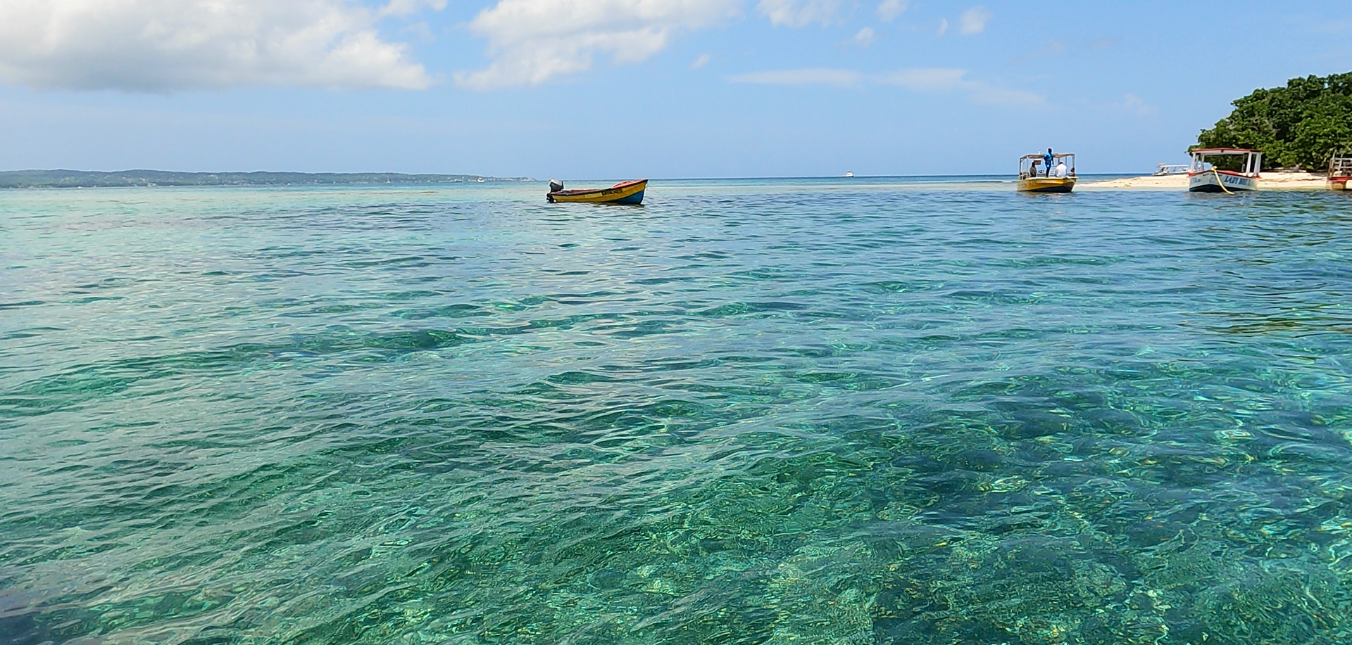 A couple of boats are floating on top of a body of water.