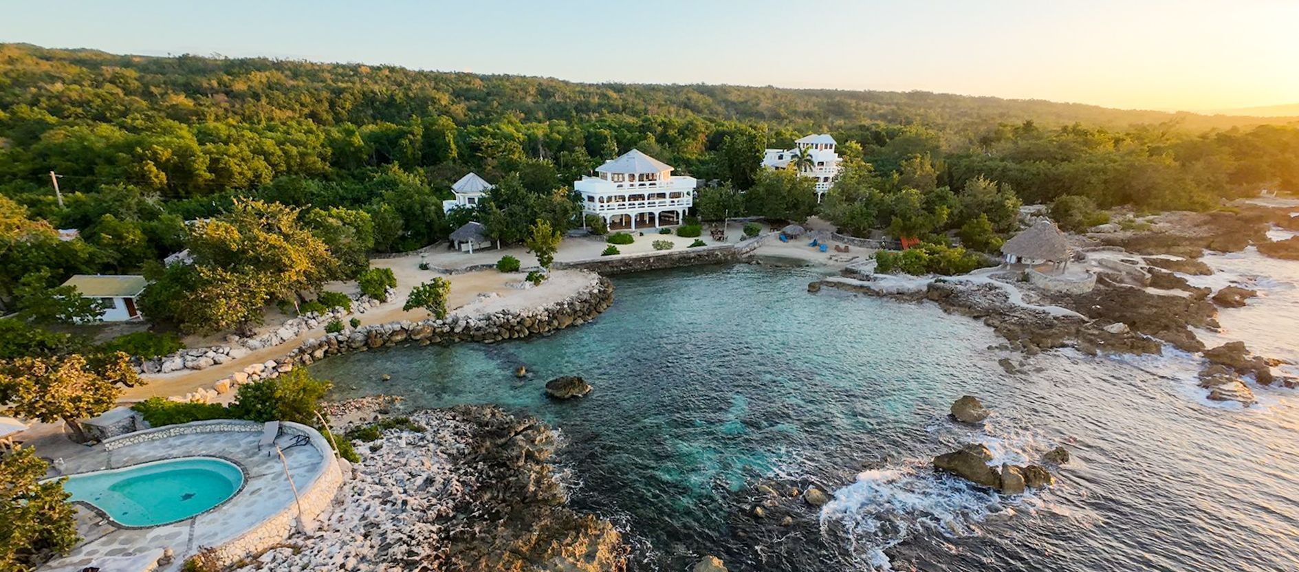 An aerial view of a large body of water surrounded by trees.