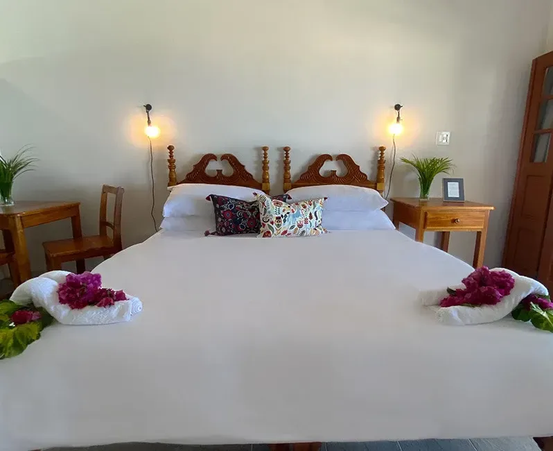 A bedroom with a king size bed and a wooden headboard