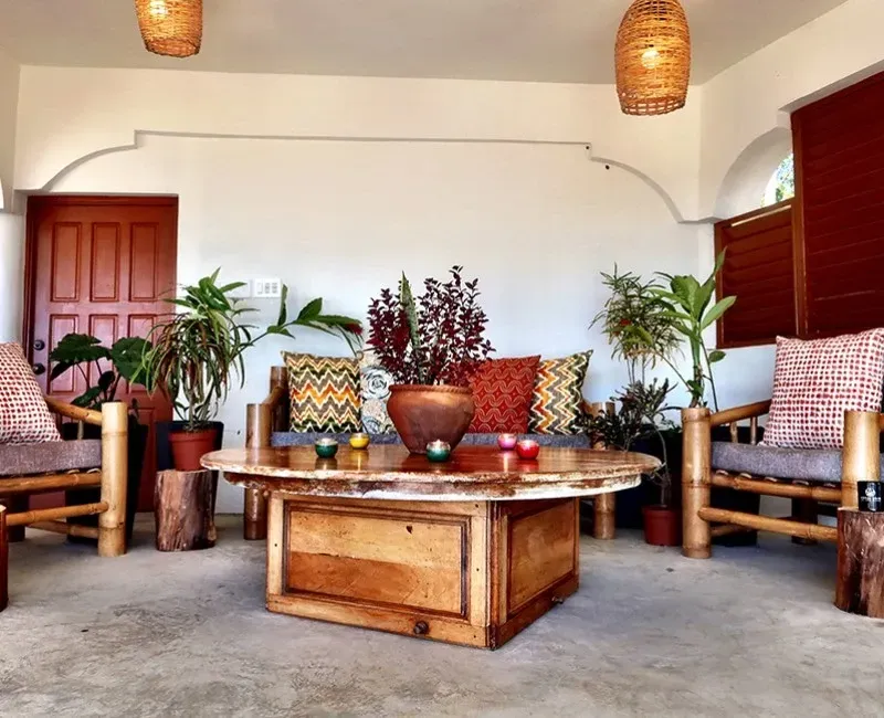 A living room with a wooden table and chairs