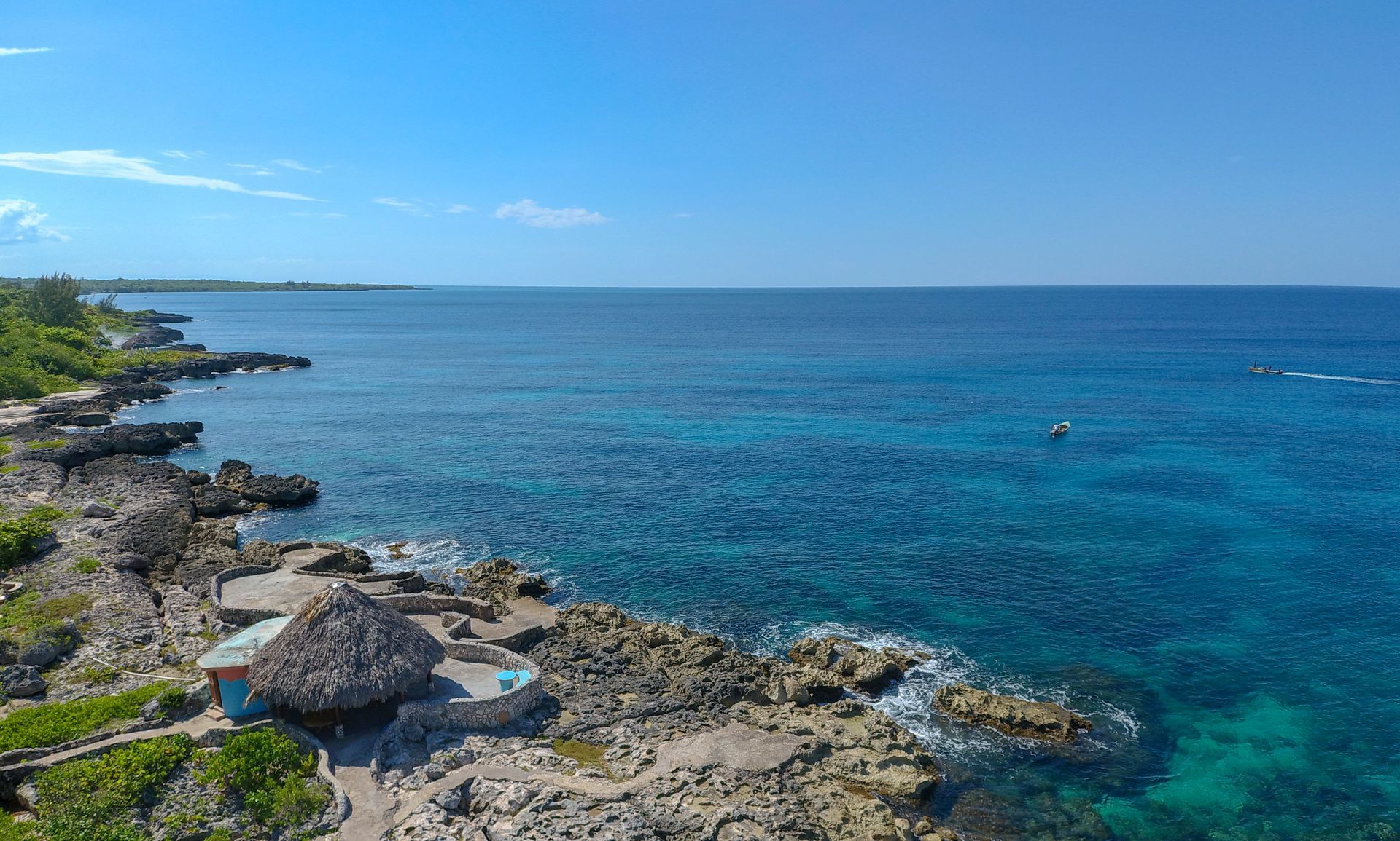 An aerial view of a rocky shoreline next to the ocean.