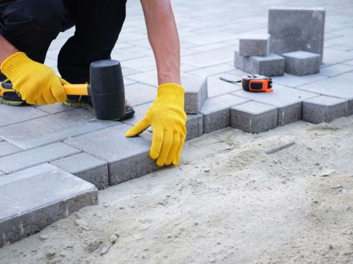 A modern two-story home with white walls, dark window frames.