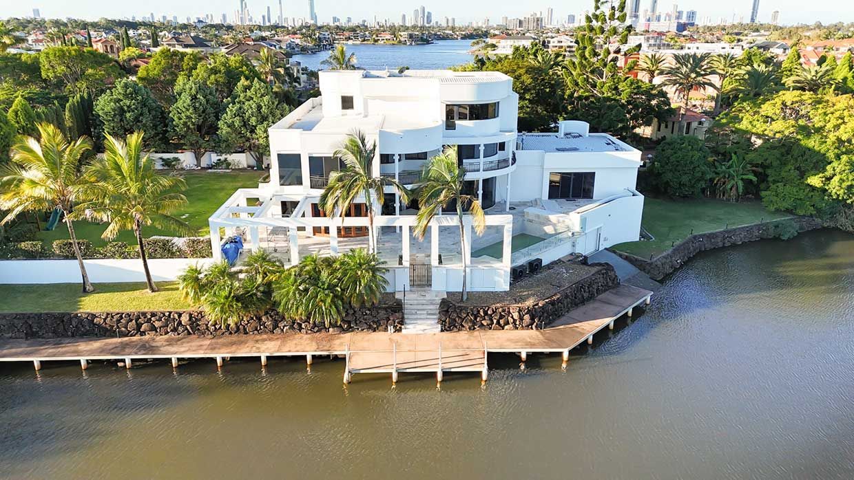 An Aerial View of a Large White House Sitting on the Shore of a Lake — TMM Painting in Coolangatta, QLD