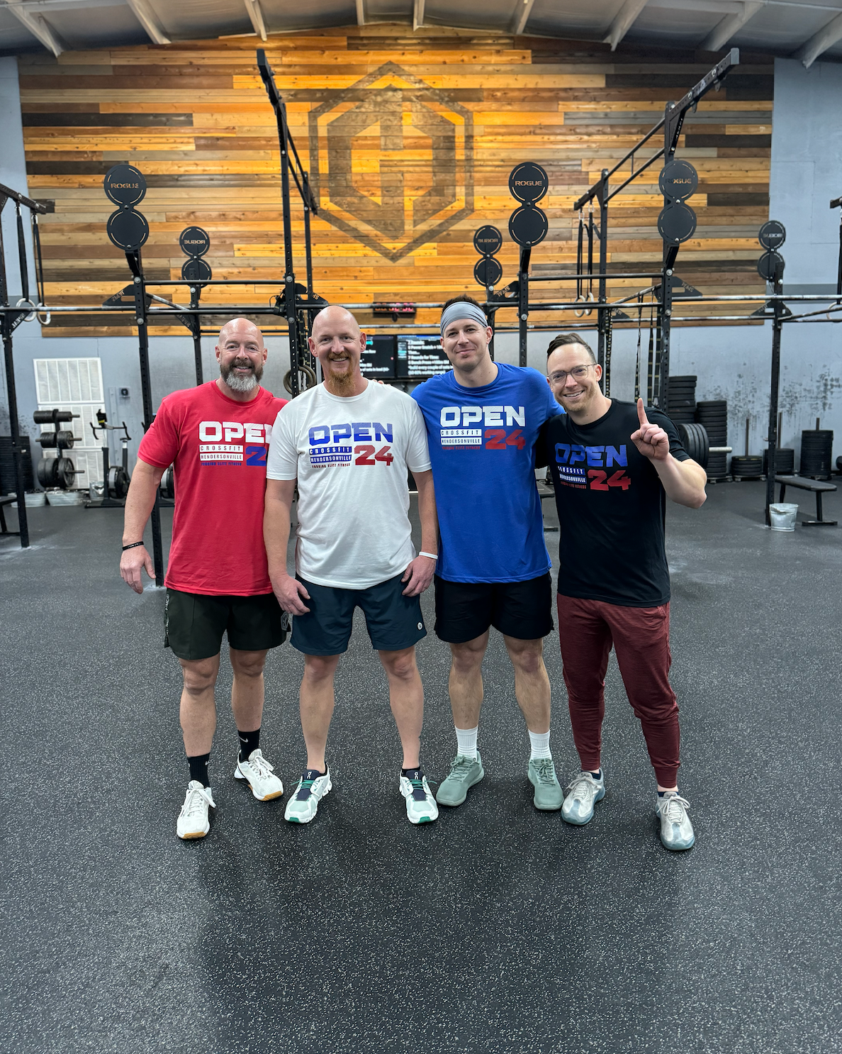 A group of men are posing for a picture in a gym.