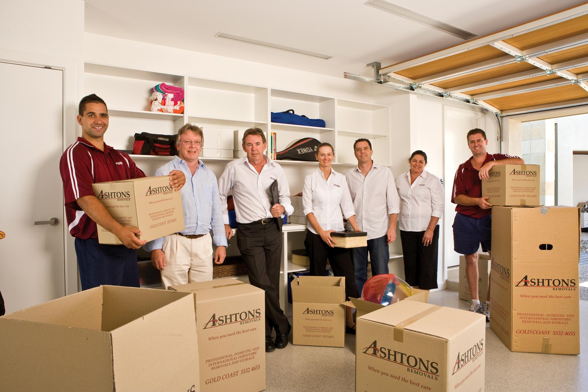 Ashtons Removals Professional Team with Box on the Floor | Molendinar, Qld | Ashtons Removals