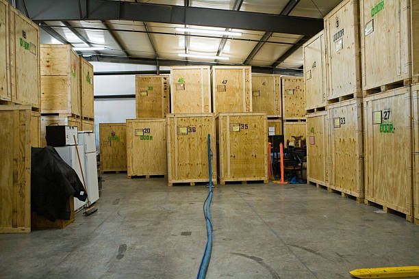 Some plywood storage modules in a warehouse, labeled with numbers.