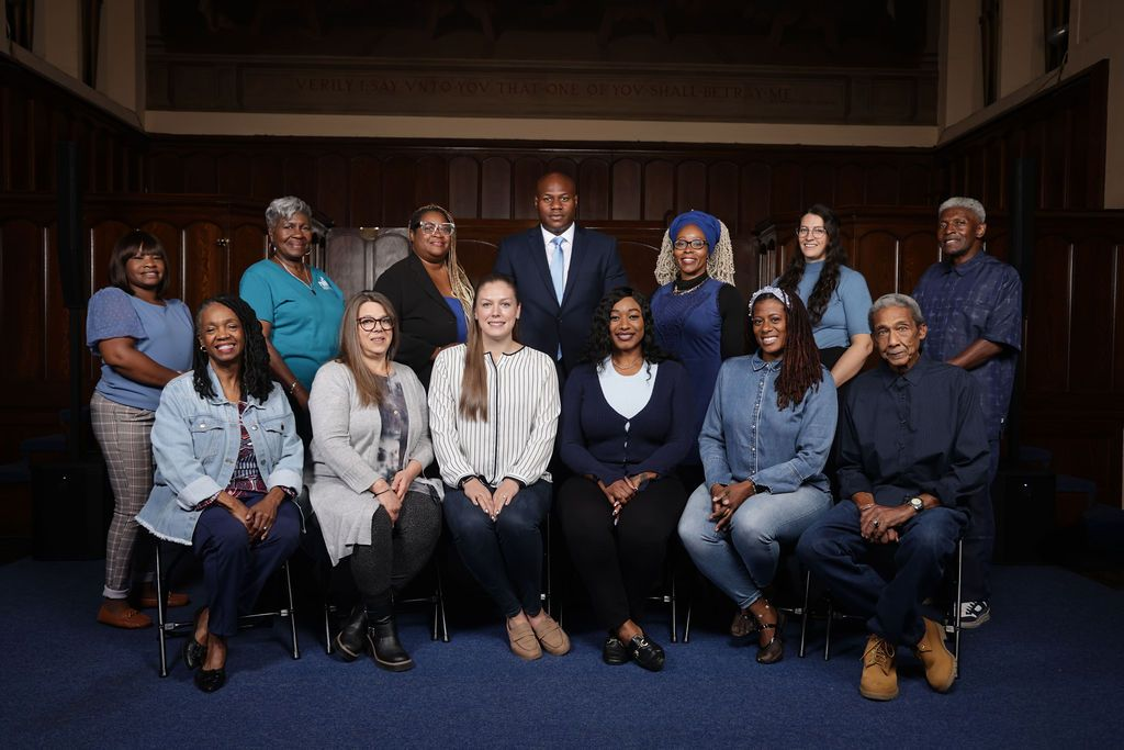 A group of people are posing for a picture in front of a building.