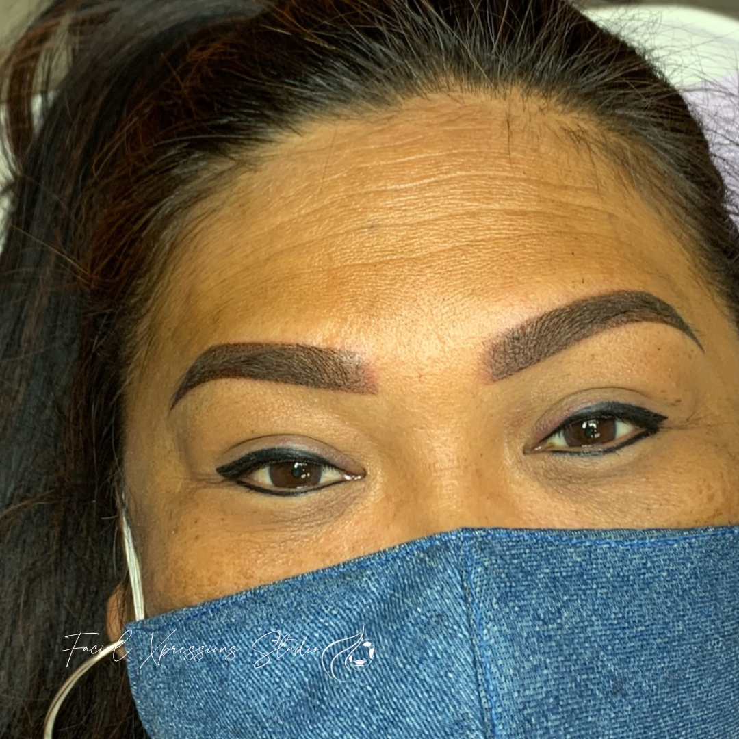 A close up of a woman wearing a blue face mask.