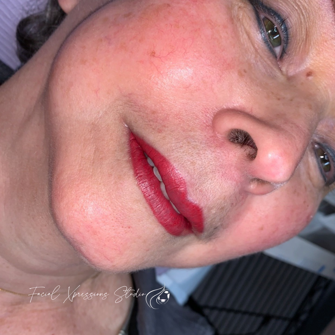 A close up of a woman 's face with red lipstick