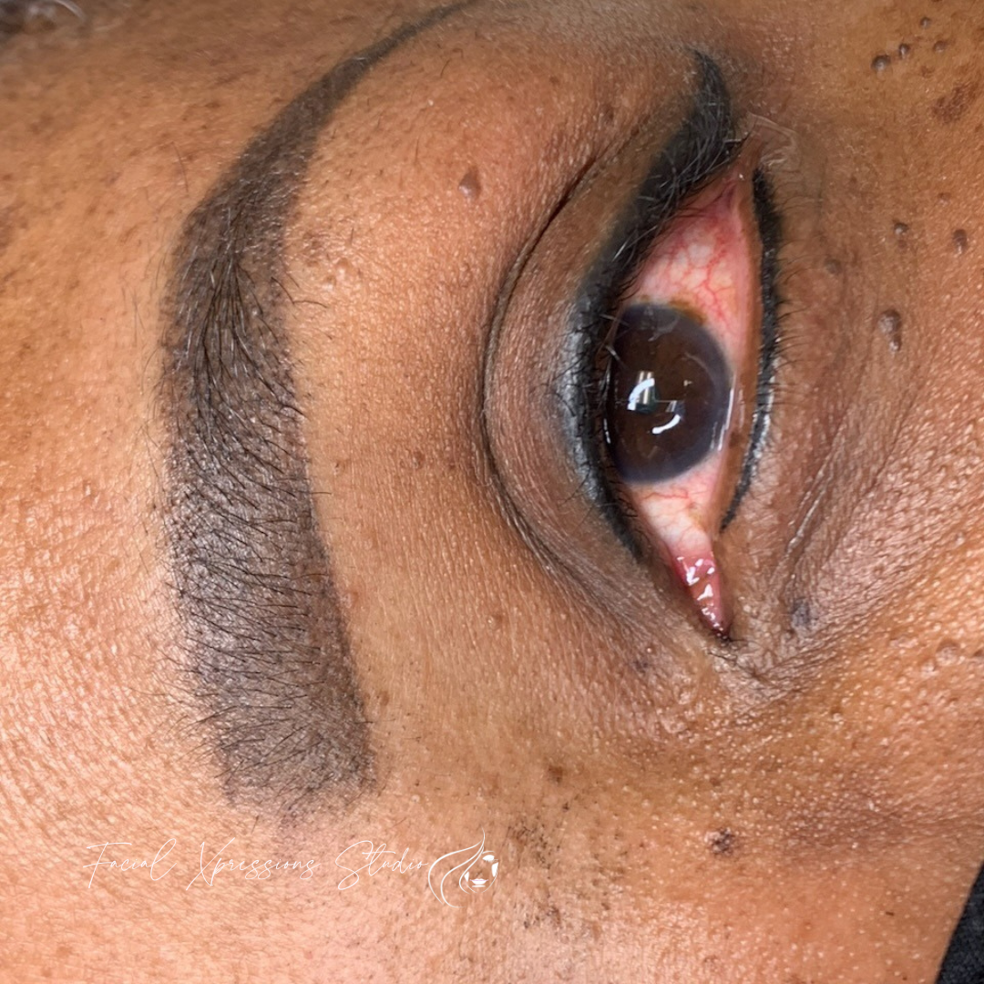 A close up of a woman 's eye with makeup on it.
