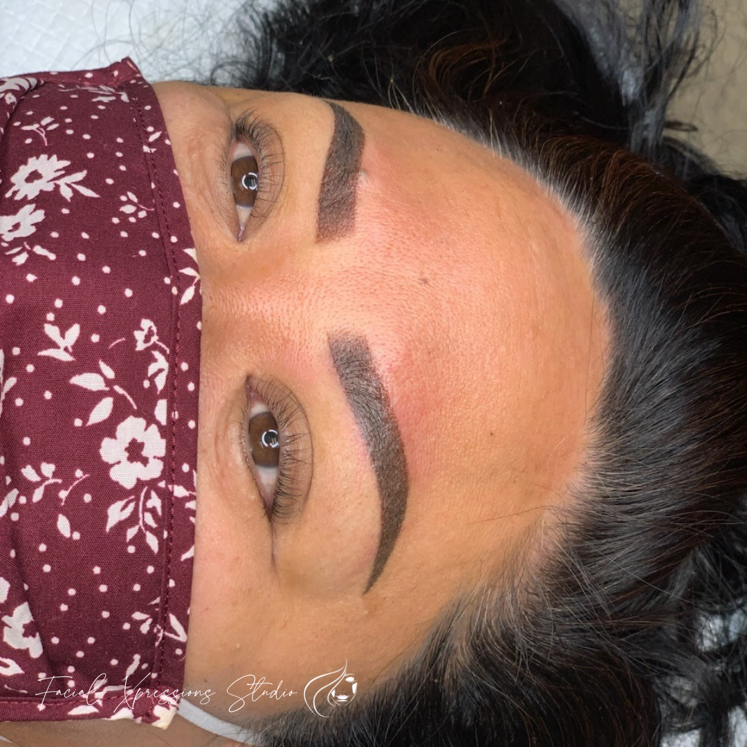 A close up of a woman wearing a face mask.