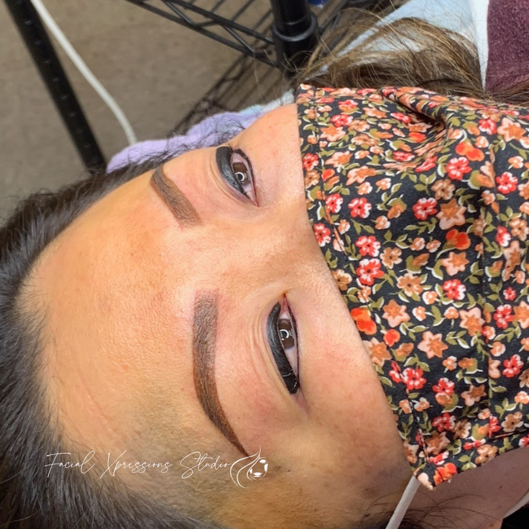 A woman is wearing a floral mask on her face.