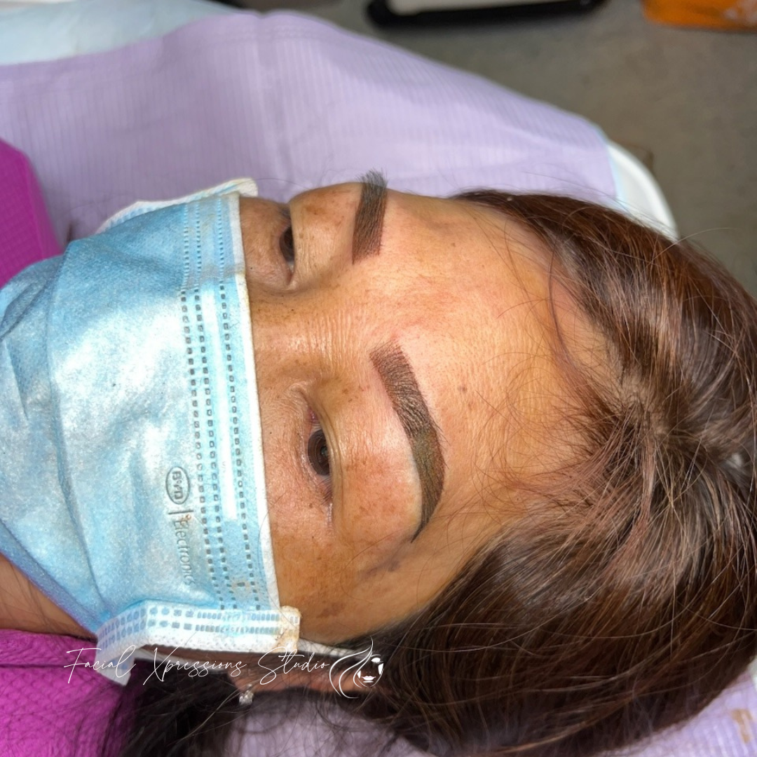 A woman is wearing a surgical mask on her face.