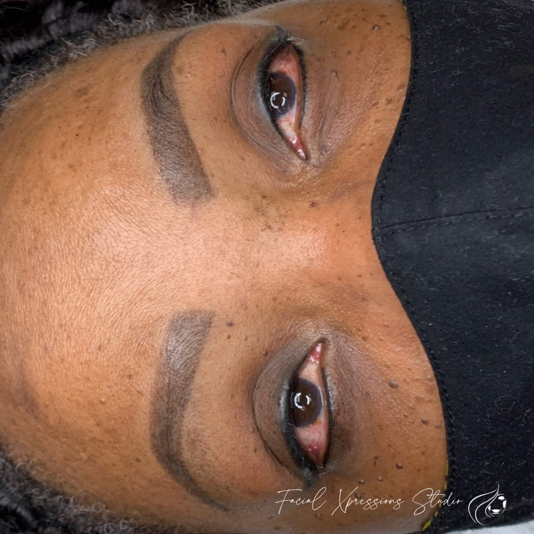 A close up of a woman 's face with a black mask on.