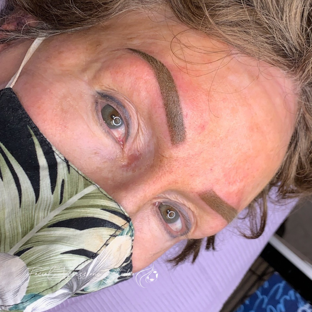 A close up of a woman wearing a face mask.