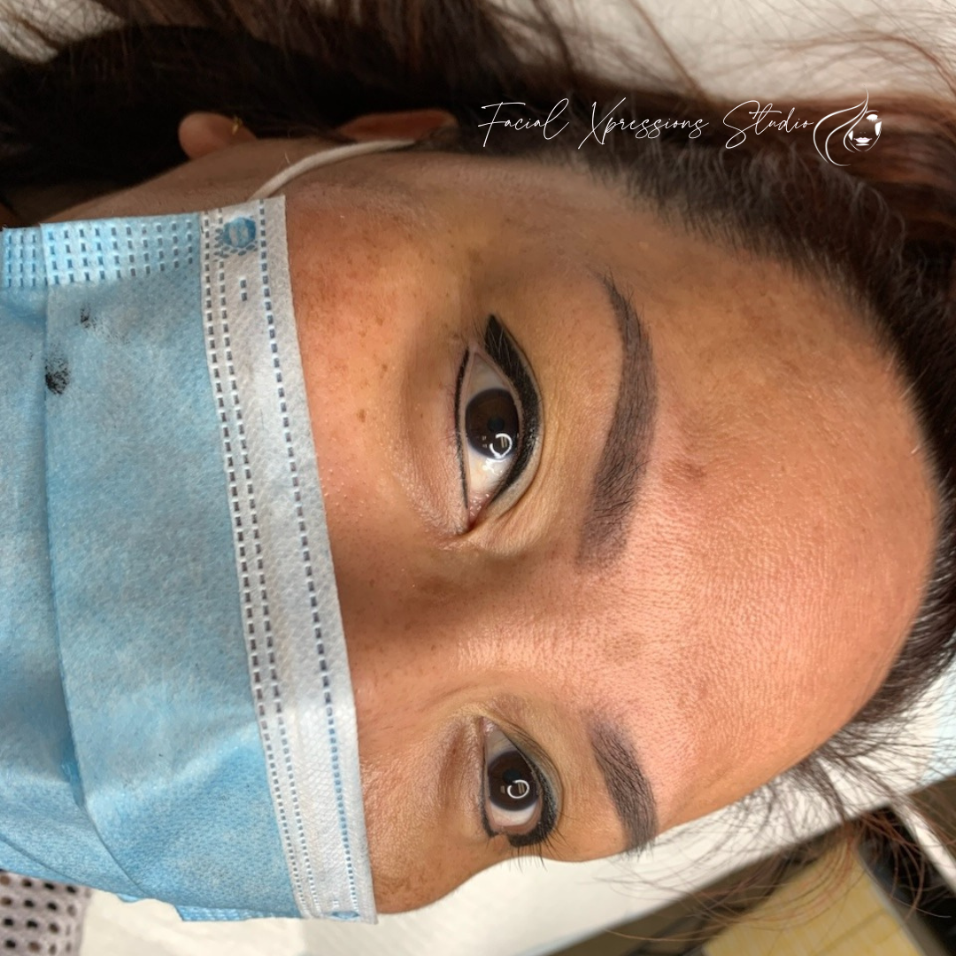 A close up of a woman wearing a face mask