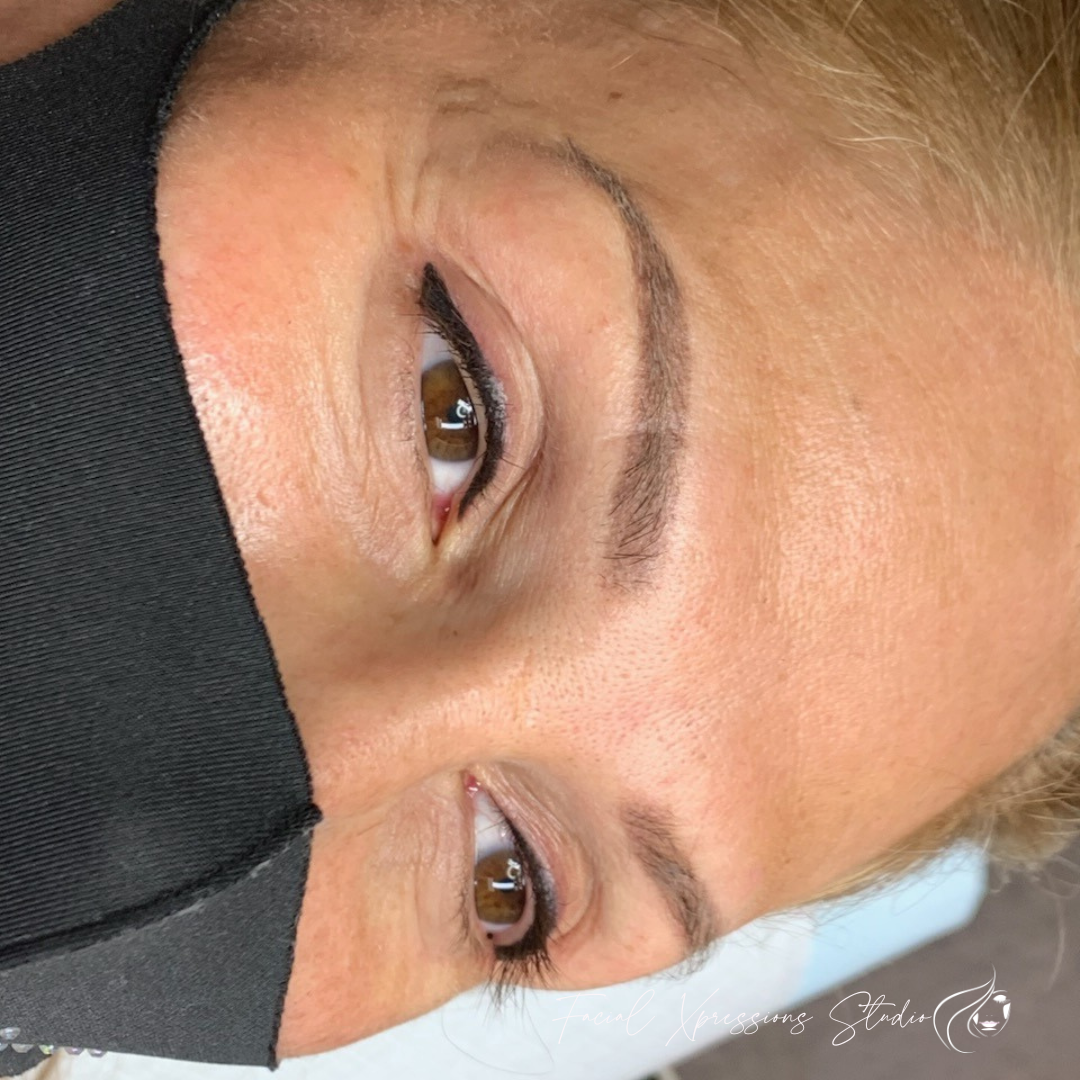A close up of a woman wearing a black mask.