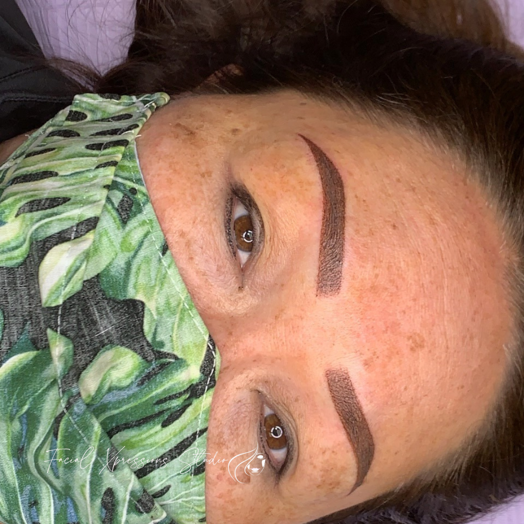 A close up of a woman wearing a mask on her face.