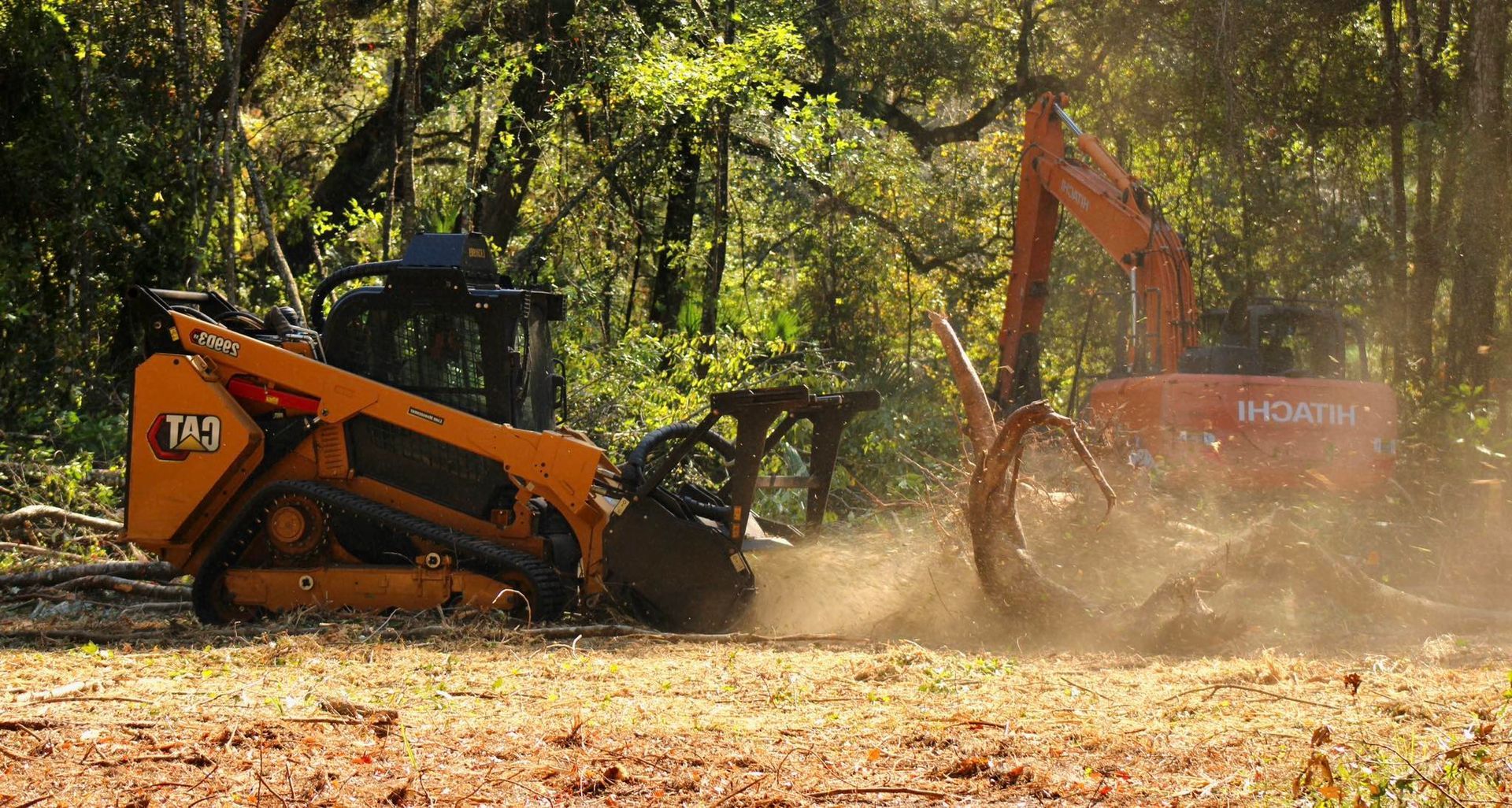 A bulldozer and an excavator are working in a field.