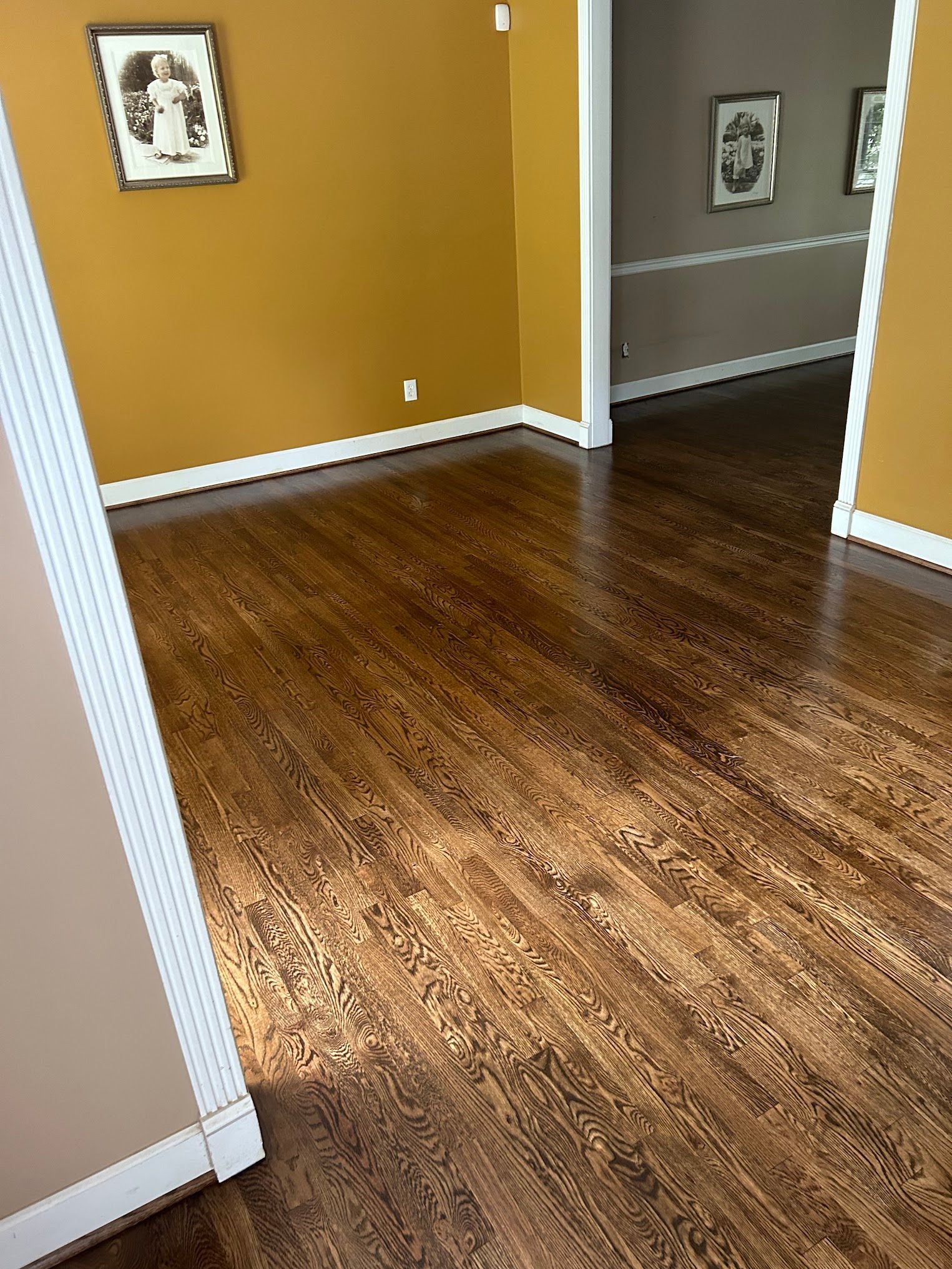 A room with hardwood floors and yellow walls.