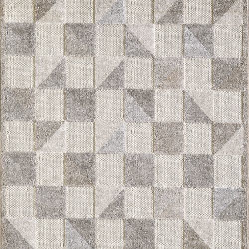 Geometric rug pattern featuring a repeating grid of textured gray and off-white squares, some split into triangles.