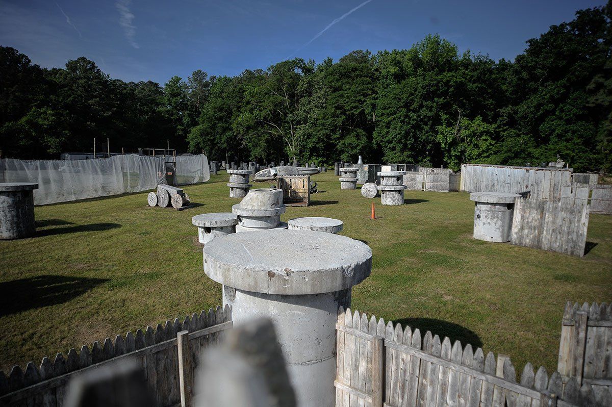 A paintball field with a fence in the middle of it