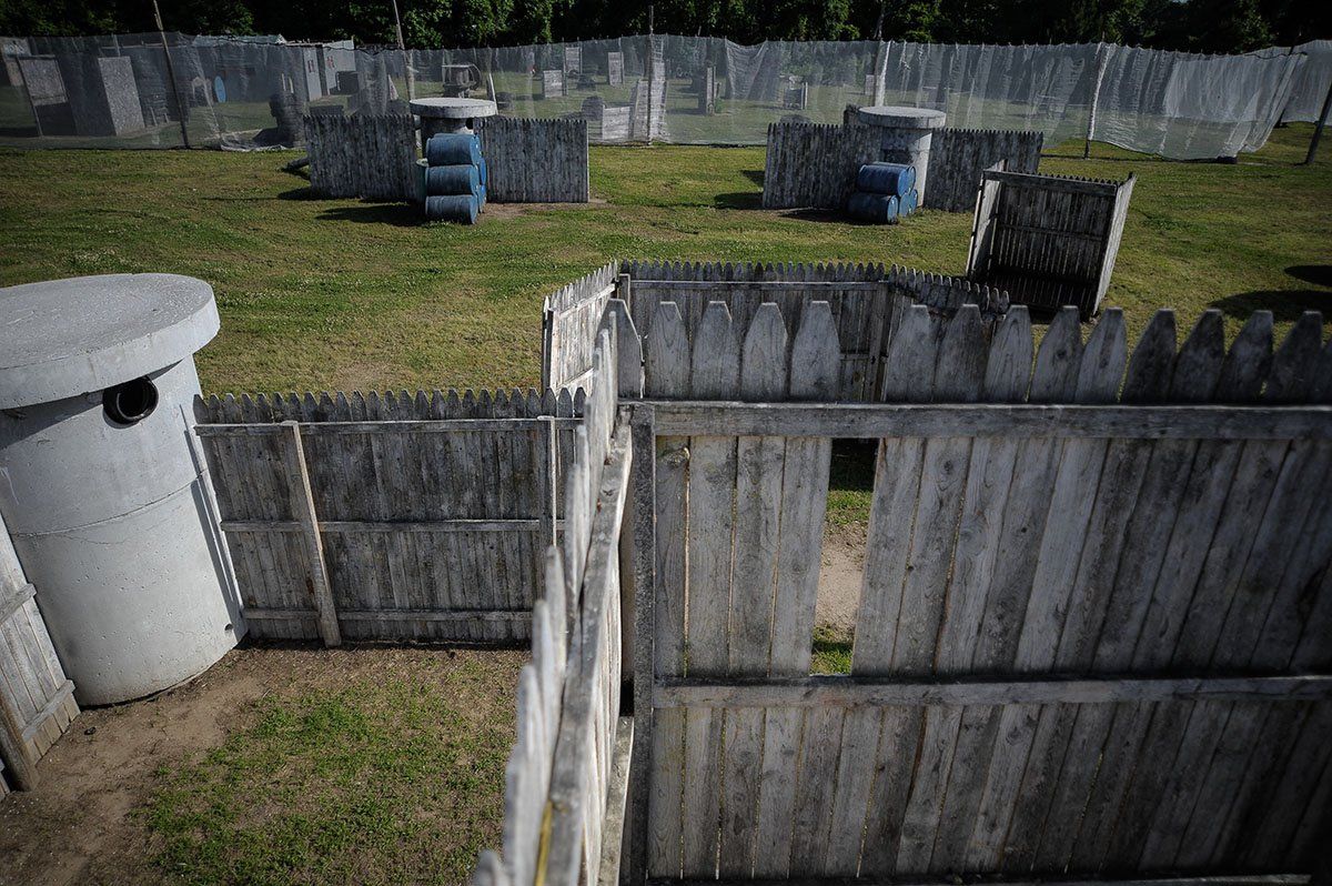An aerial view of a paintball field with a wooden fence surrounding it.
