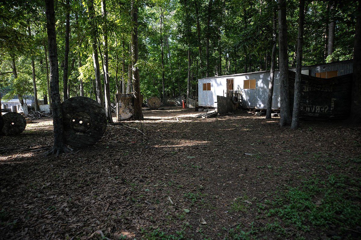 A trailer is parked in the middle of a forest.