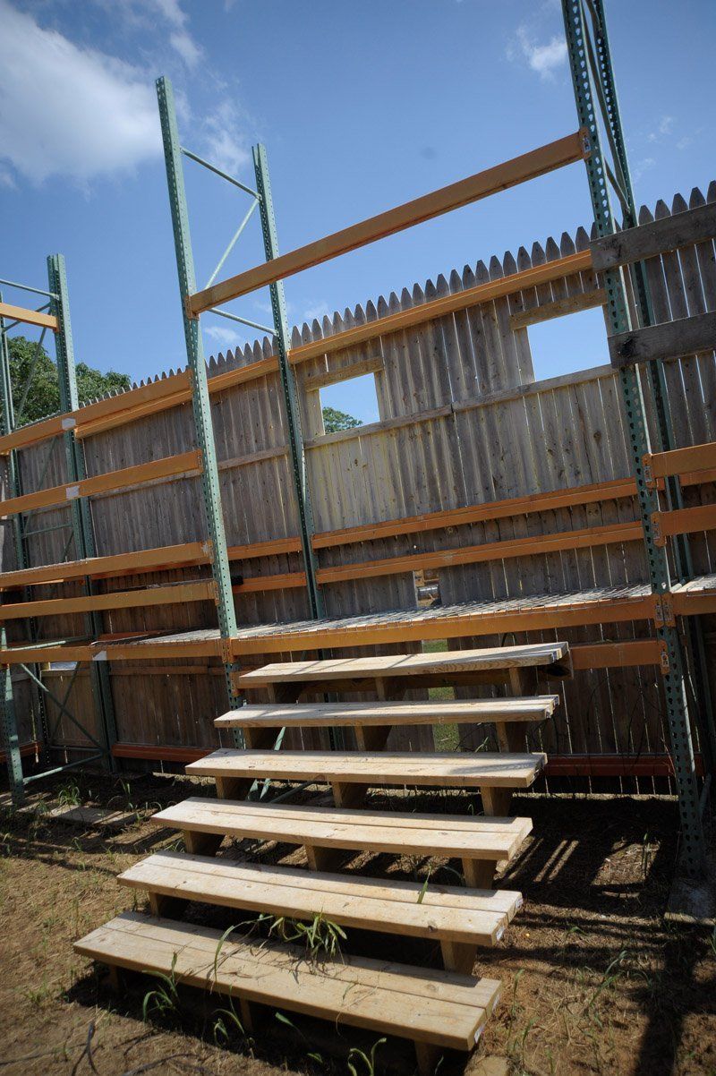 A wooden staircase leading up to a building under construction