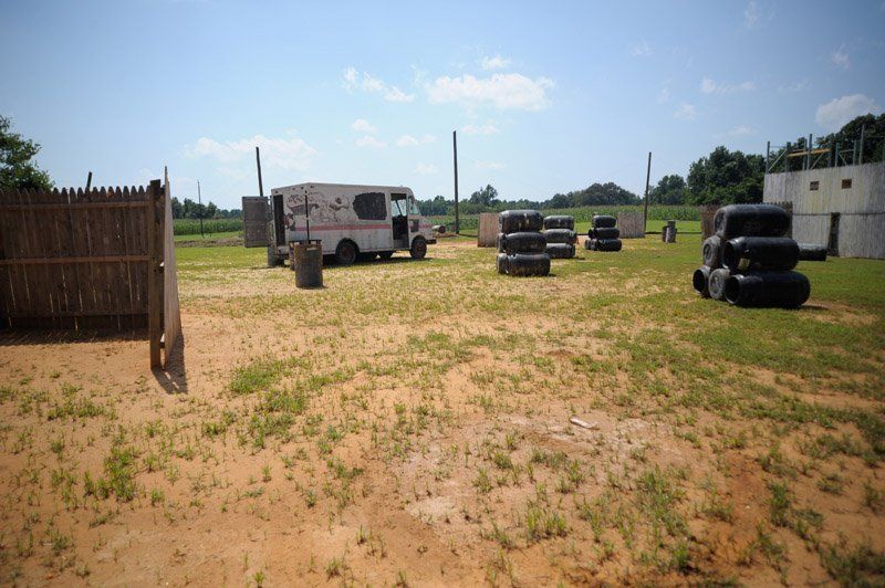 An ambulance is parked in the middle of a field.