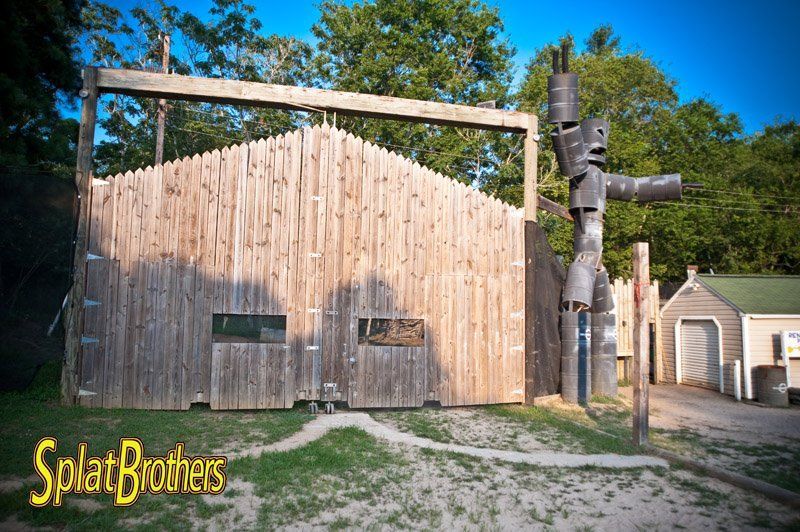 A wooden building with a totem pole in front of it.
