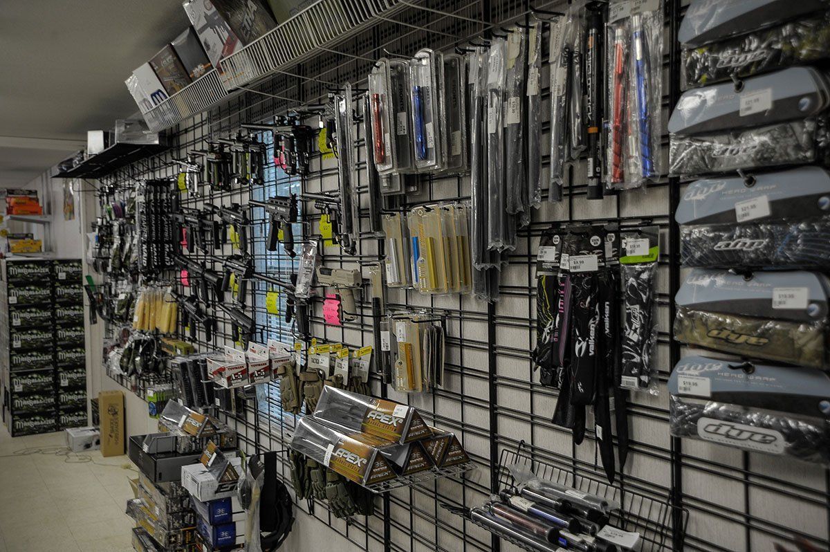 A bunch of tools are hanging on a wall in a store.