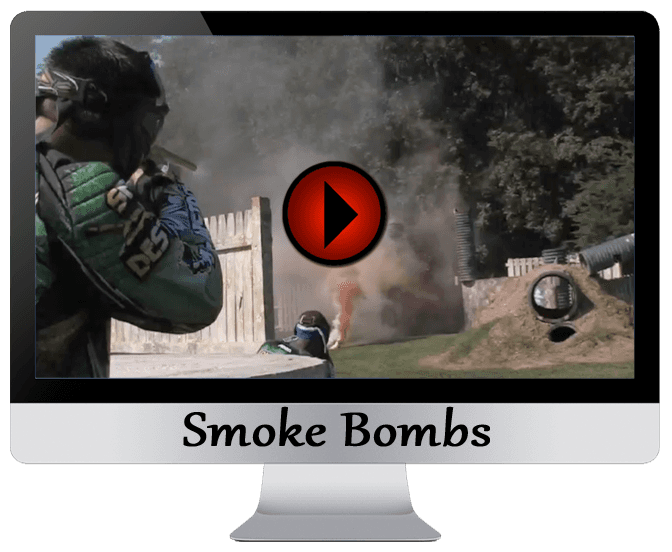 A monitor displaying paintball action with smoke bombs; a player aims, person runs in the smoke.