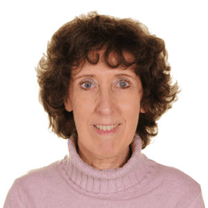 A woman wearing a pink sweater smiles for the camera