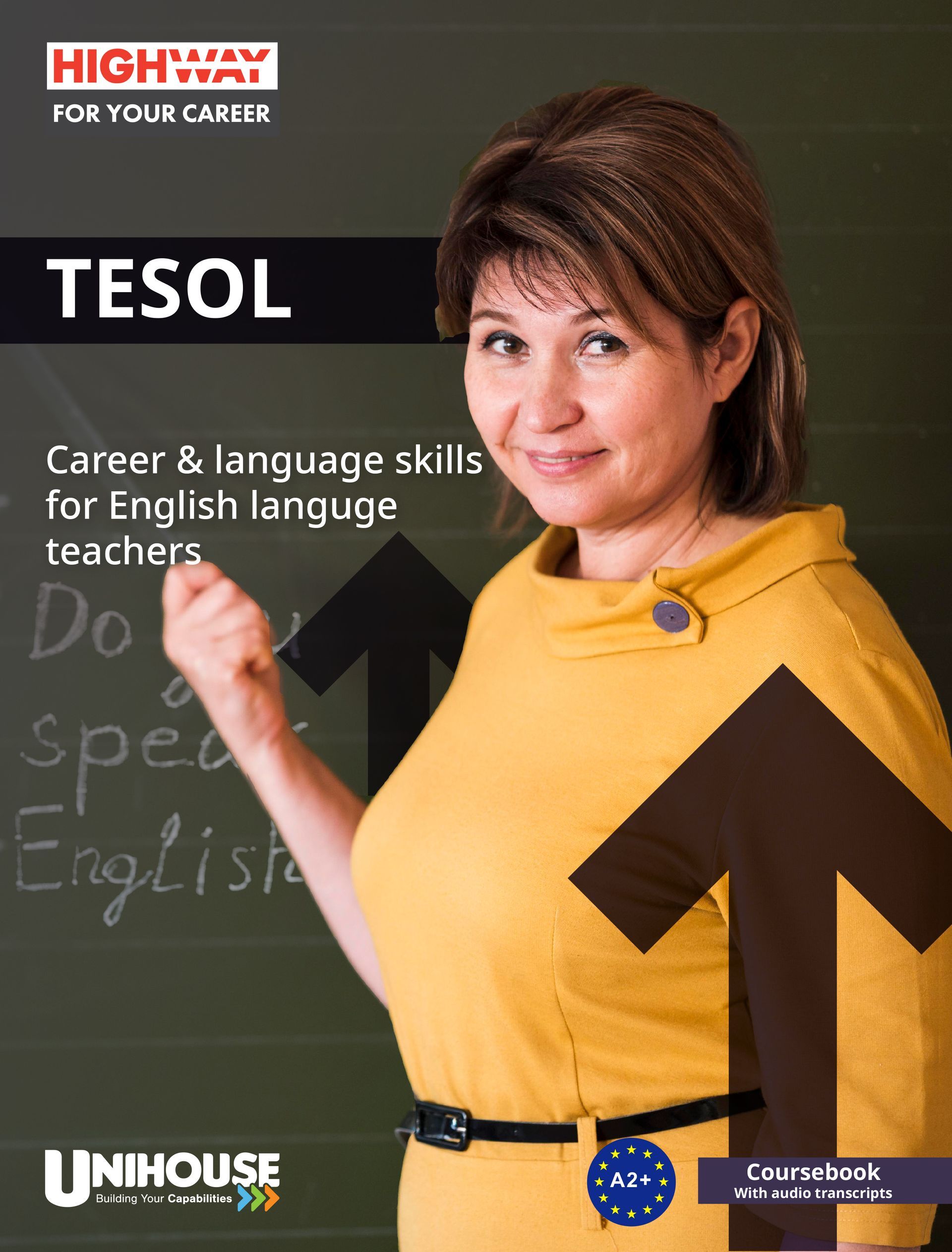 A woman standing in front of a blackboard with the word tesol on it