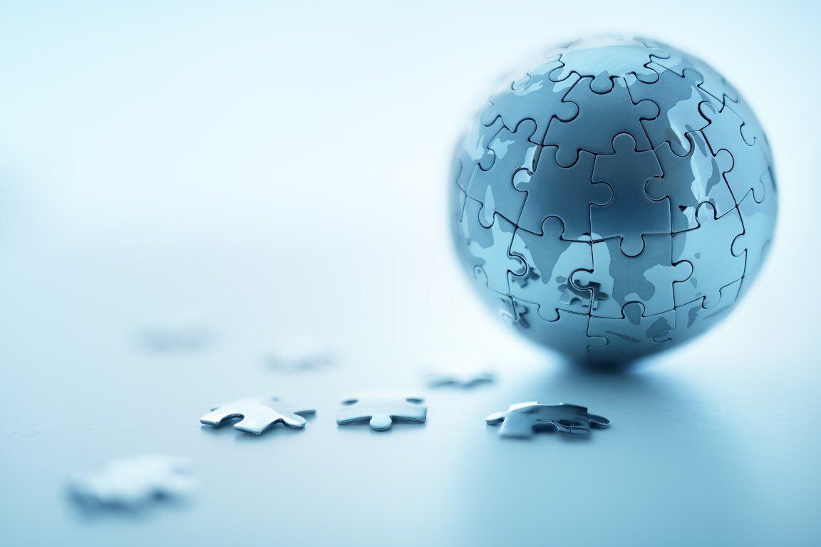 A globe made out of puzzle pieces on a table