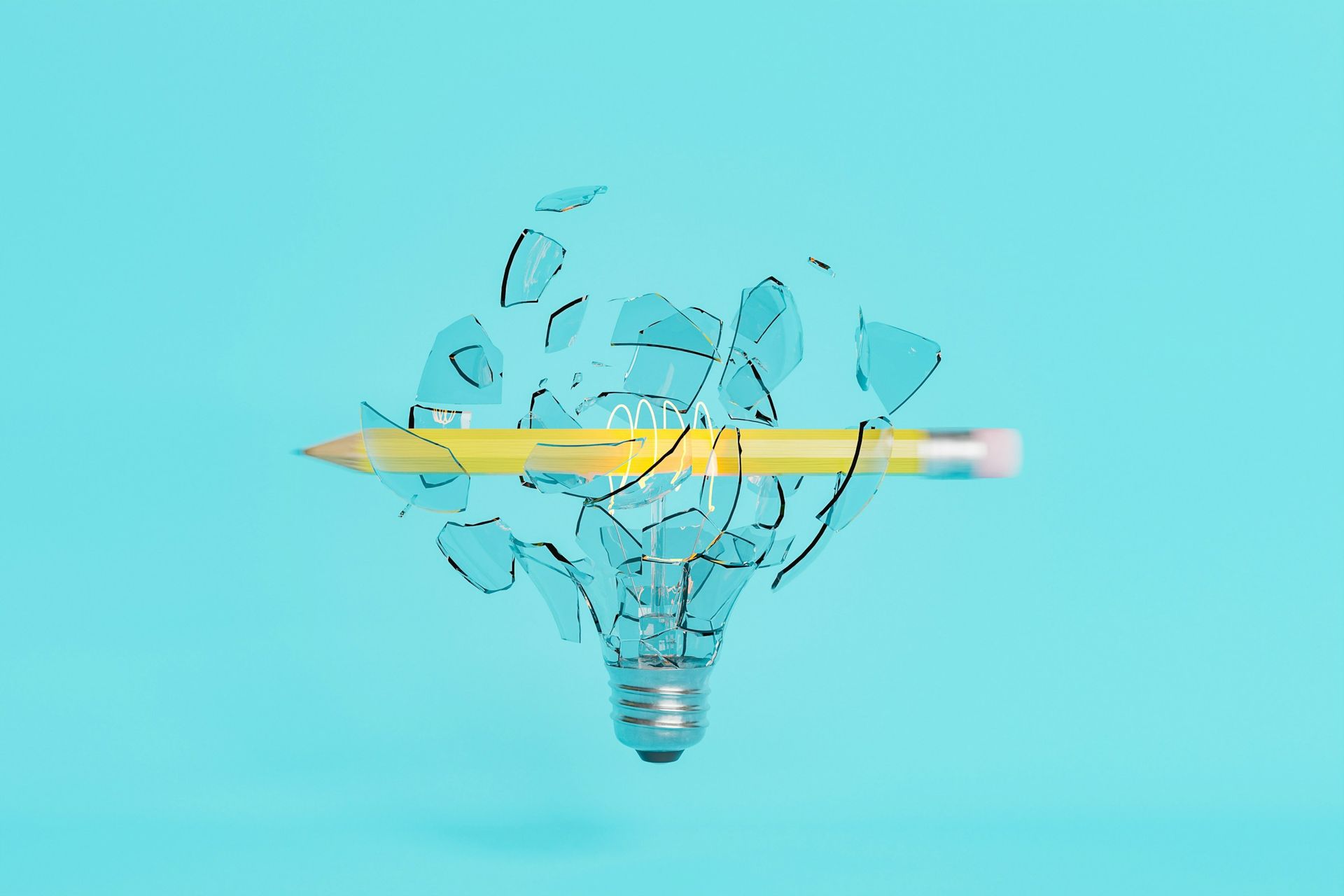 A pencil shattering a glass lightbulb, symbolizing breakthrough ideas and opportunities