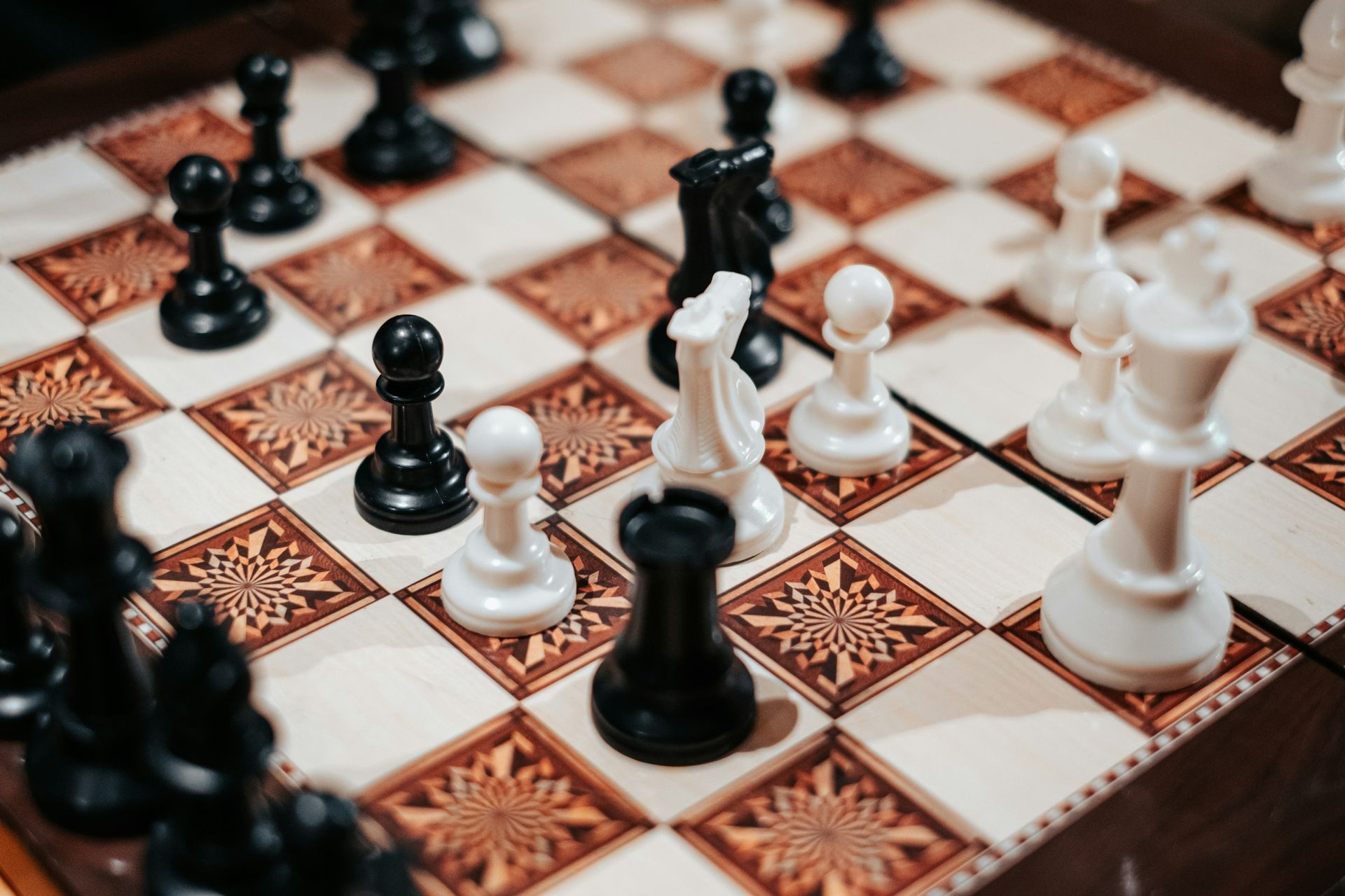 A decorative chessboard mid-game, symbolizing the strategic planning required for successful scholarship management